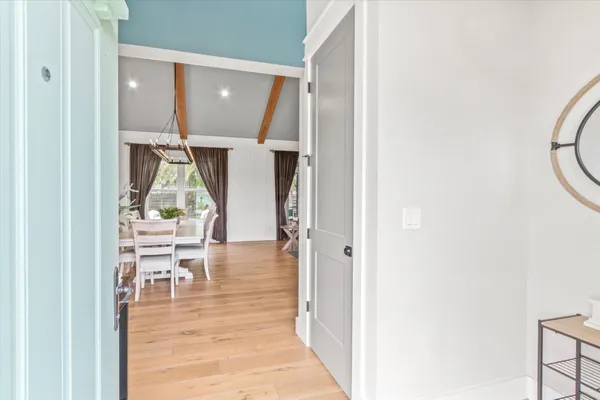 a living room with furniture a large window with kitchen view