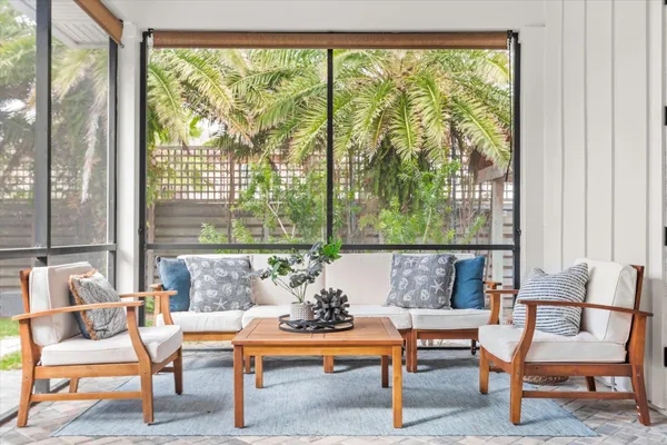 a view of a house with backyard and a sitting area