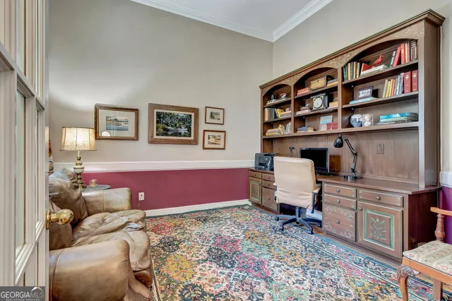 a living room with furniture a fireplace and a chandelier