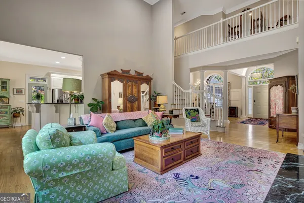 a kitchen with stainless steel appliances granite countertop a kitchen island a stove a sink dishwasher and cabinets with wooden floor