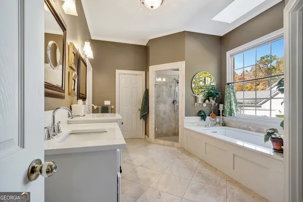 a spacious bathroom with a granite countertop sink a mirror and a
