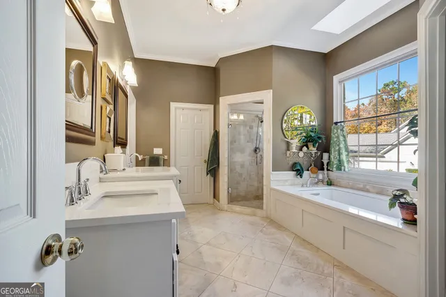 a spacious bathroom with a granite countertop sink a mirror and a