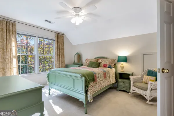 a view of a hallway with wooden floor and livingroom