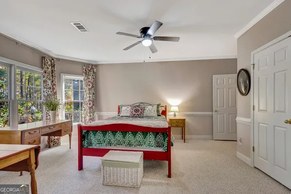 a bathroom with a granite countertop sink mirror vanity and toilet