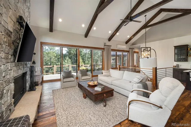 a living room with furniture fireplace and flat screen tv