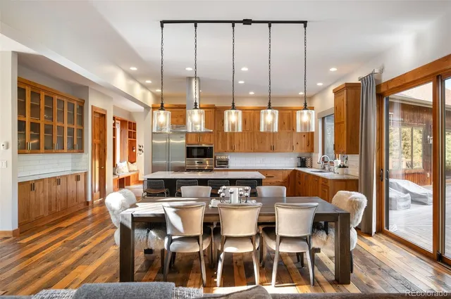 a dining table with chairs and window