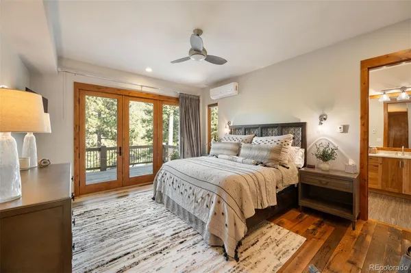 a bedroom with a large bed and a large window