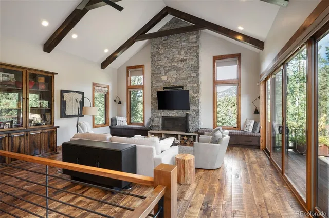 a view of a livingroom with furniture and large windows