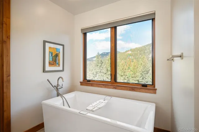 a white bath tub sitting next to a window