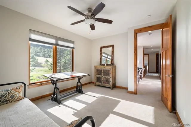 a view of a livingroom with furniture and a window