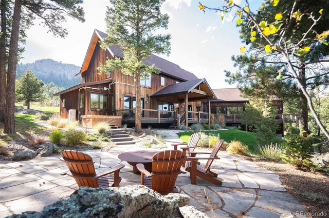 a front view of a house with garden and sitting area