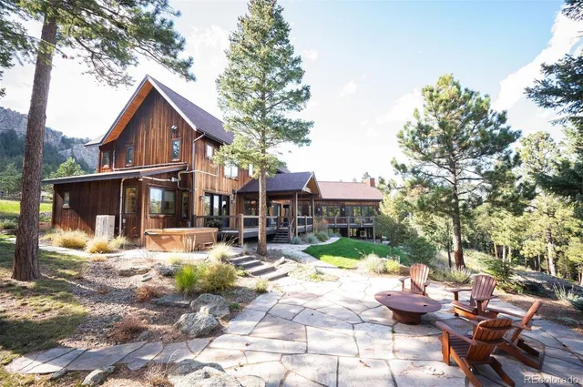 a view of backyard of house with outdoor seating