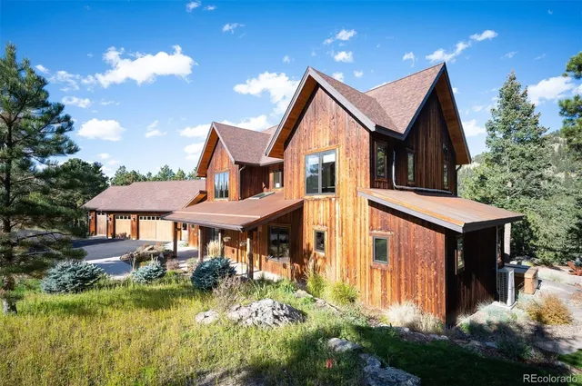 a front view of a house with swimming pool having outdoor seating