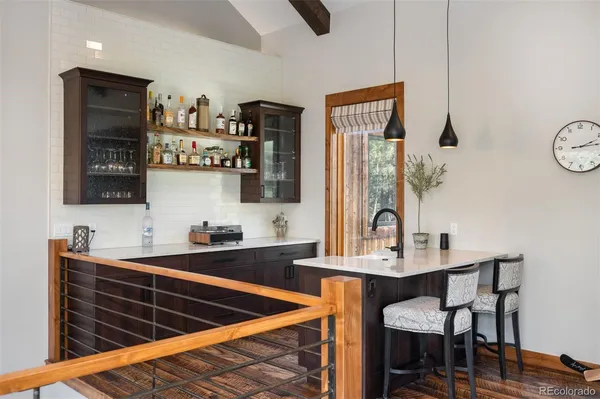 a kitchen with stainless steel appliances a sink cabinets and wooden floor