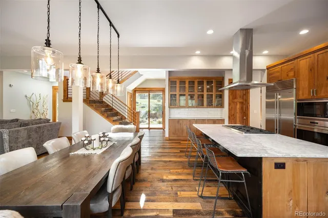 a dining table with chairs and kitchen view