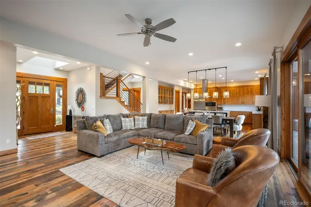 a living room with furniture ceiling fan and a rug