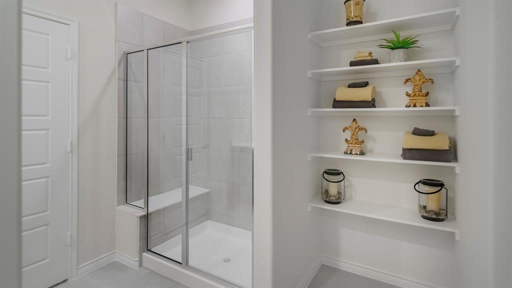 410 Range Road Caddo Mills, TX 75135 - Photo 13 of 19 Glass-enclosed shower with a built-in bench and light-toned tile surround