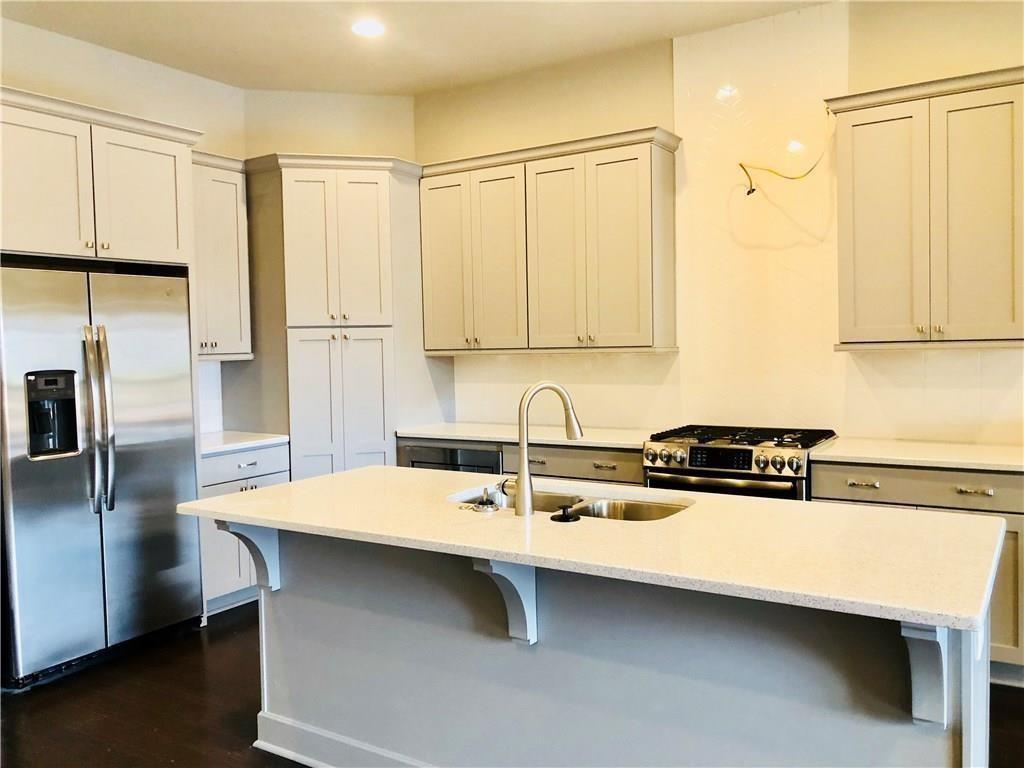 257 Franklin Road Sandy Springs, GA 30342 - Photo 4 of 14 a kitchen with a sink a refrigerator and cabinets