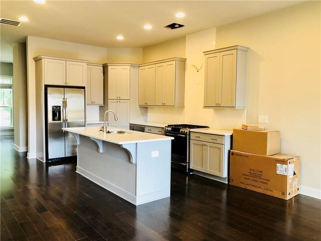 257 Franklin Road Sandy Springs, GA 30342 - Photo 6 of 14 a kitchen with stainless steel appliances granite countertop a sink a stove a refrigerator and white cabinets