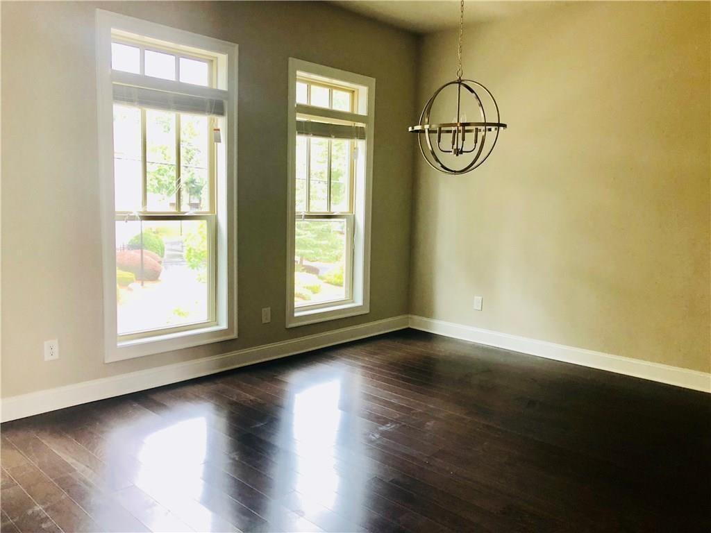 257 Franklin Road Sandy Springs, GA 30342 - Photo 8 of 14 an empty room with wooden floor and windows
