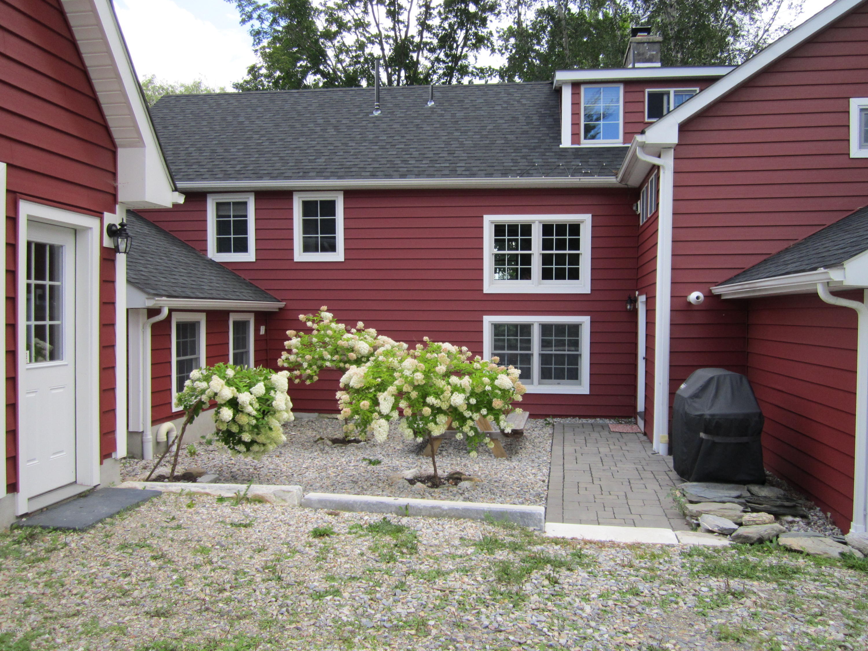 202-204 Whitman Road Hancock, MA 01267 - Photo 13 of 59 a front view of a house with garden