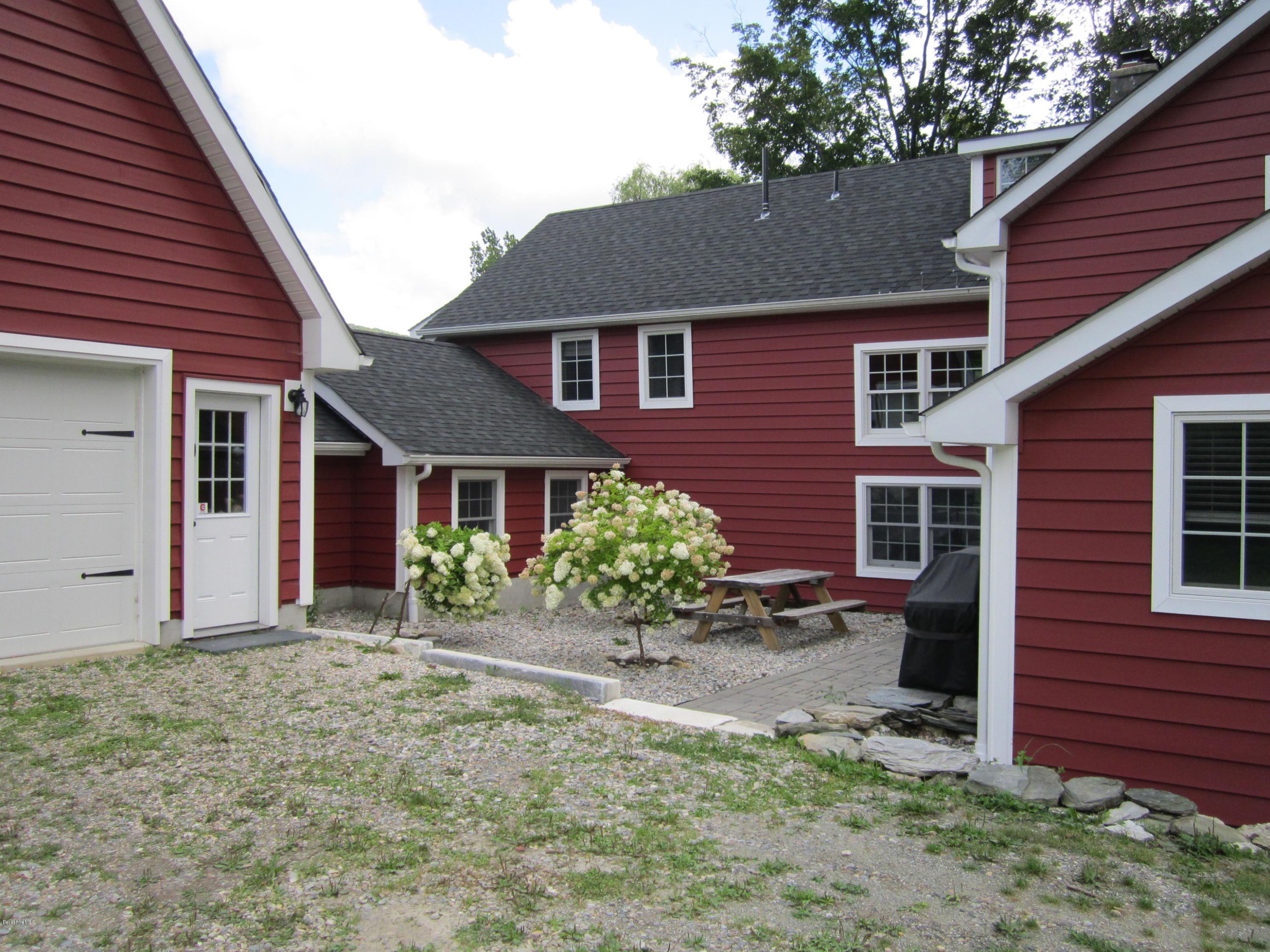 202-204 Whitman Road Hancock, MA 01267 - Photo 14 of 59 a front view of a house with a garden