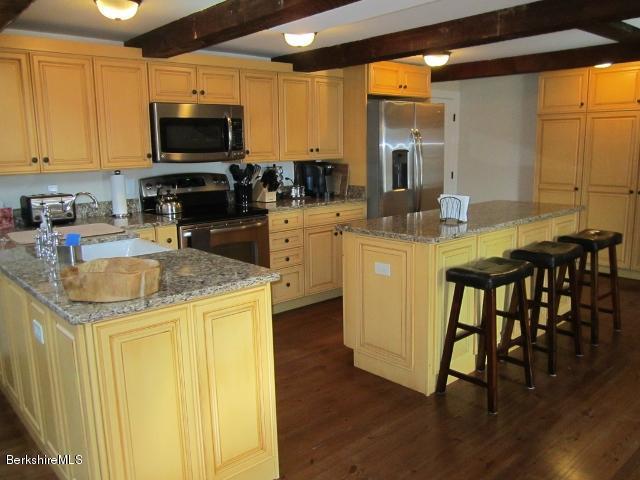 202-204 Whitman Road Hancock, MA 01267 - Photo 18 of 59 a kitchen with stainless steel appliances granite countertop a stove a sink a microwave and a refrigerator