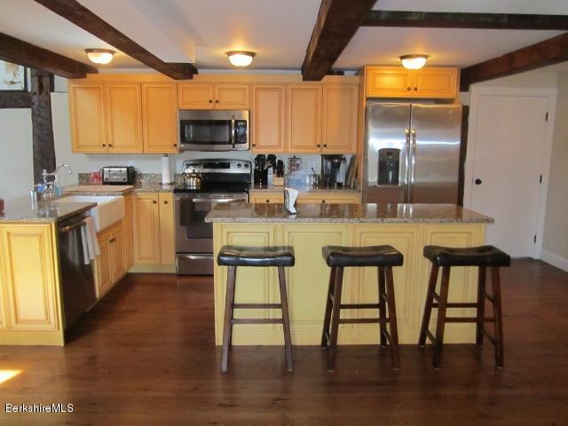 202-204 Whitman Road Hancock, MA 01267 - Photo 20 of 59 a kitchen with a table chairs microwave and cabinets