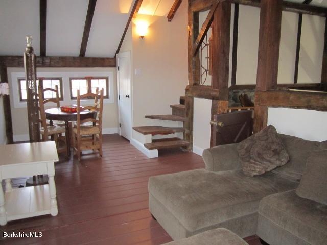 202-204 Whitman Road Hancock, MA 01267 - Photo 32 of 59 a living room with couches a dining table with kitchen view and wooden floor
