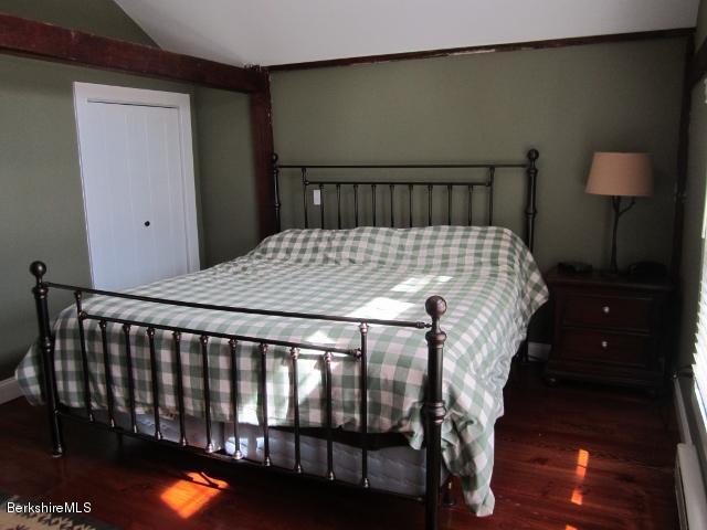 202-204 Whitman Road Hancock, MA 01267 - Photo 35 of 59 a bed sitting in a bedroom next to a lamp
