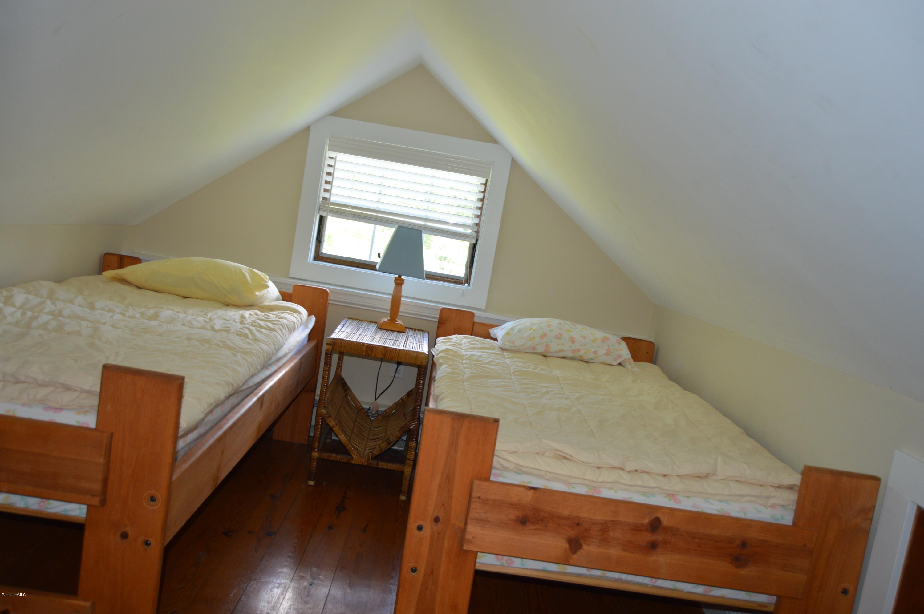 202-204 Whitman Road Hancock, MA 01267 - Photo 56 of 59 a bedroom with a bed and wooden floor
