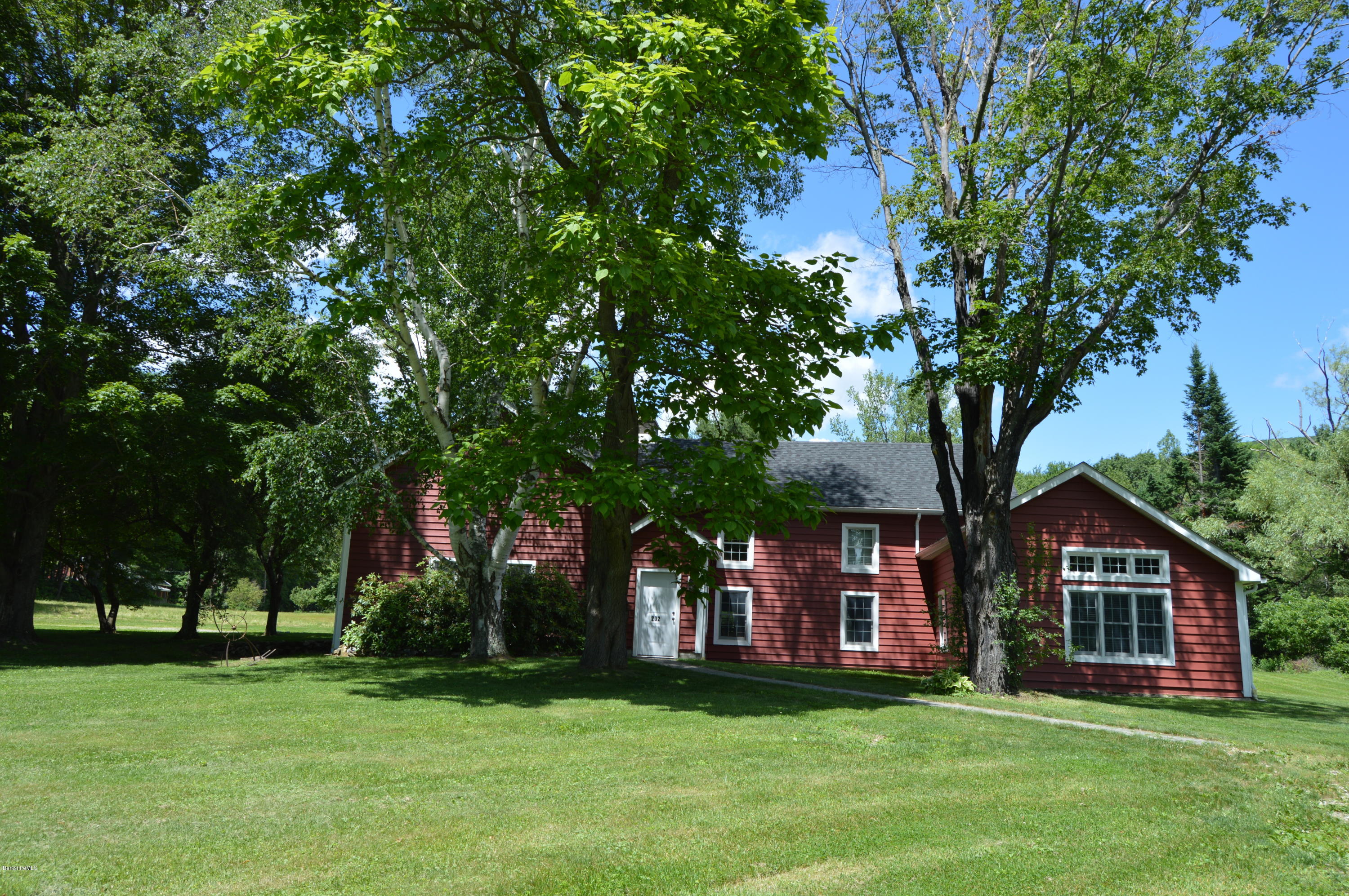 202-204 Whitman Road Hancock, MA 01267 - Photo 9 of 59 a front view of a house with a garden