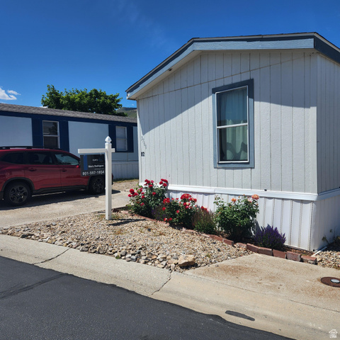 3760 Gold Ridge Drive, Unit 82 Magna, UT 84044 - Photo 3 of 29 White siding exterior with a light blue roof trim