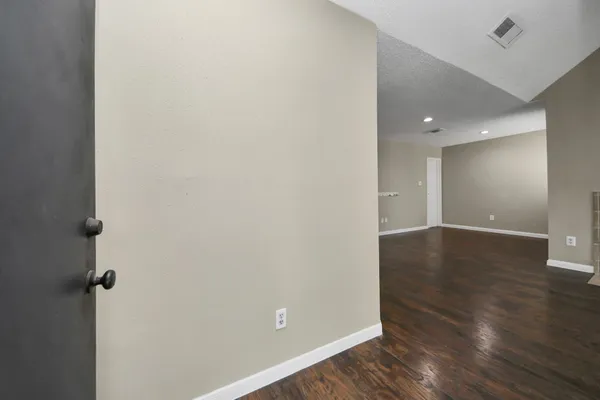 a view of a room with wooden floor