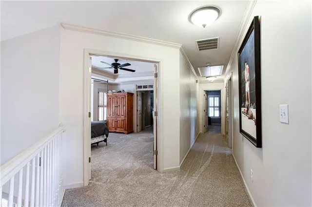 a spacious bedroom with a bed and a chandelier