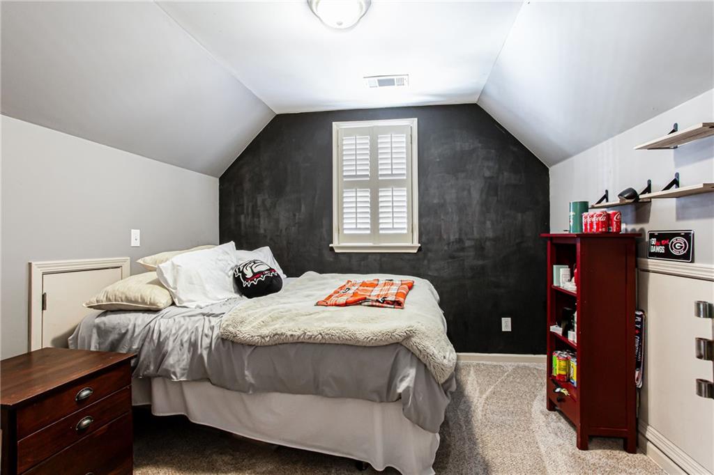 4010 Rockingham Drive Roswell, GA 30075 - Photo 24 of 36 a bedroom with a bed and a window