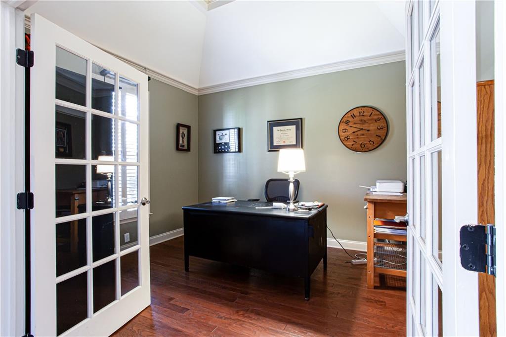 4010 Rockingham Drive Roswell, GA 30075 - Photo 4 of 36 a view of a workspace with furniture and wooden floor