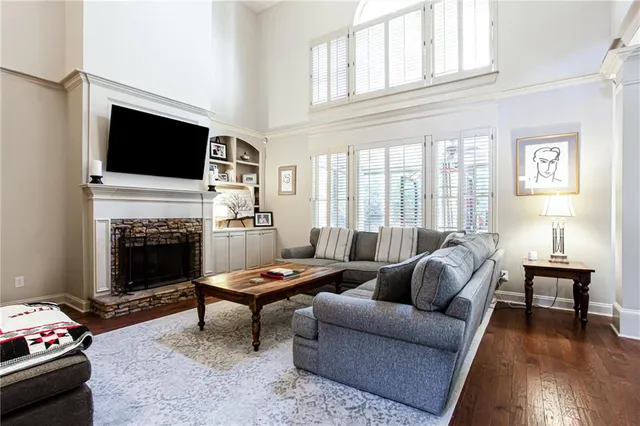 a living room with furniture a flat screen tv and a fireplace