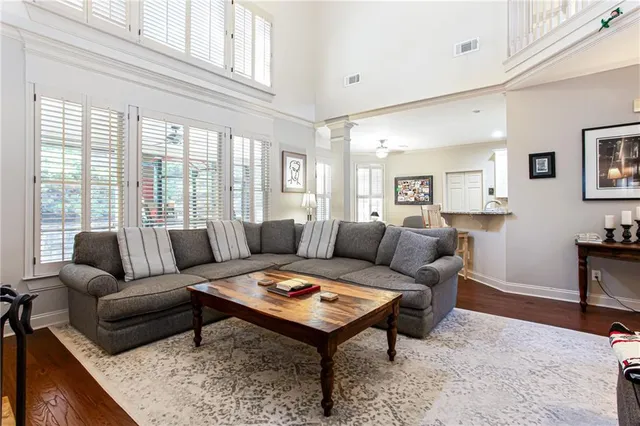 a living room with furniture a rug and a window