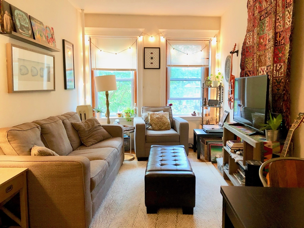 a living room with furniture fireplace and a flat screen tv