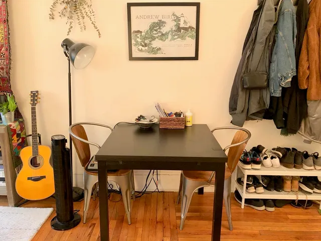 a view of a dining room with furniture and wooden floor