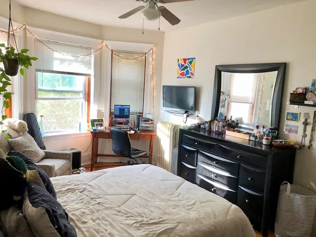 a bedroom with a bed and a desk
