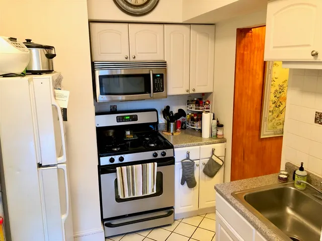 a kitchen with stainless steel appliances a stove a microwave and cabinets