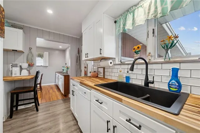 a kitchen with stainless steel appliances a refrigerator and a stove top oven
