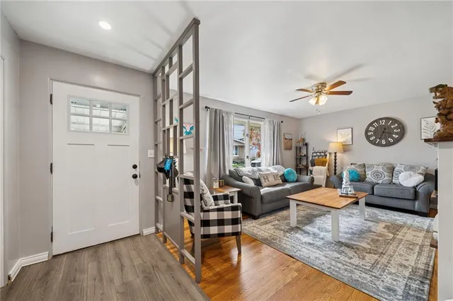 a living room with furniture and wooden floor