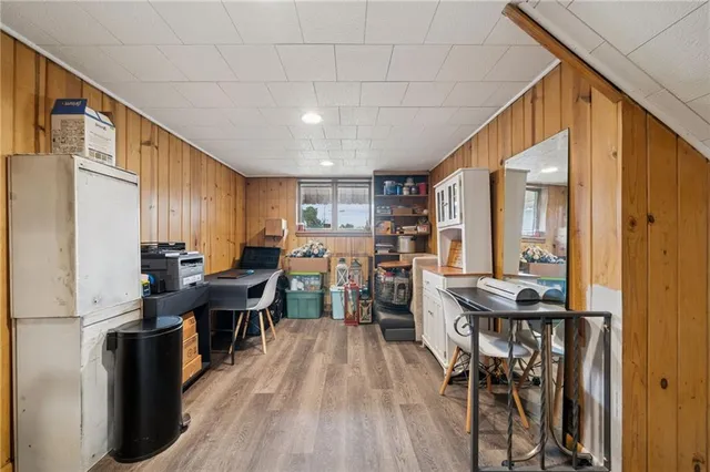 a view of a house with a yard and a large tree