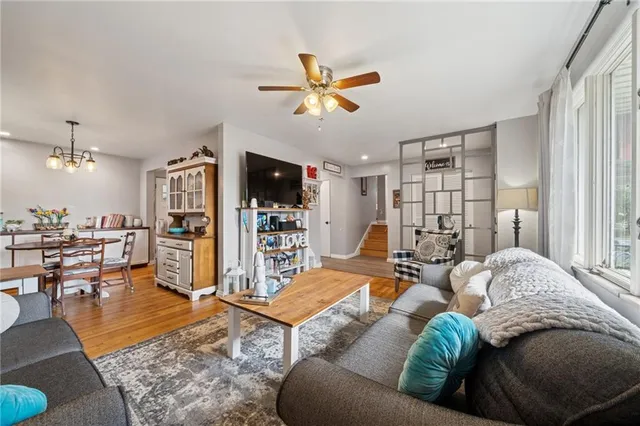 a dining room with furniture a rug and wooden floor