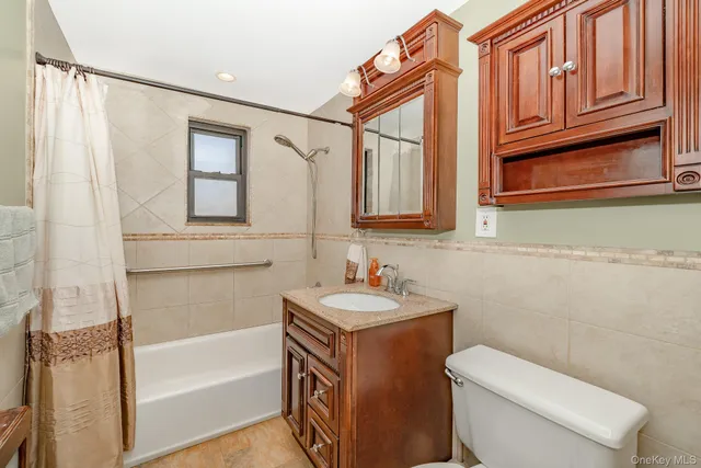 a bathroom with a sink a toilet and bathtub