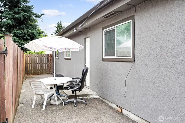 a view of a patio with a table and chairs