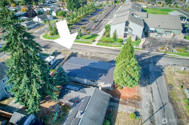 an aerial view of a house with a yard and garden